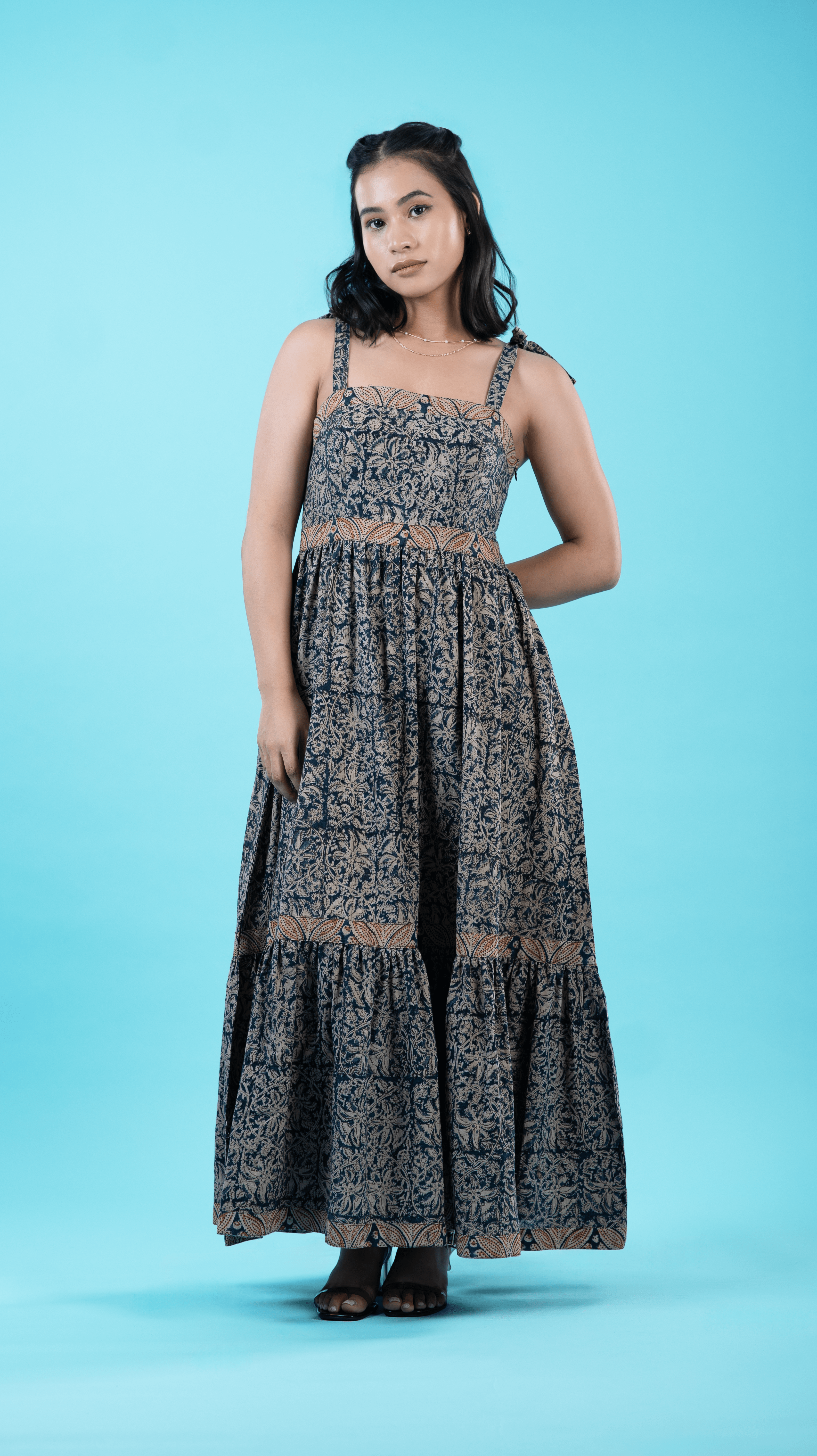 Women's dress in indigo with tie-up straps, featuring 100% lightweight cotton fabric. This cotton dress for women is designed as a midi dress with flair, including practical pockets and stylish panel work, perfect for any casual day out. Discover the chic and comfy strappy dress from Sevy.in.