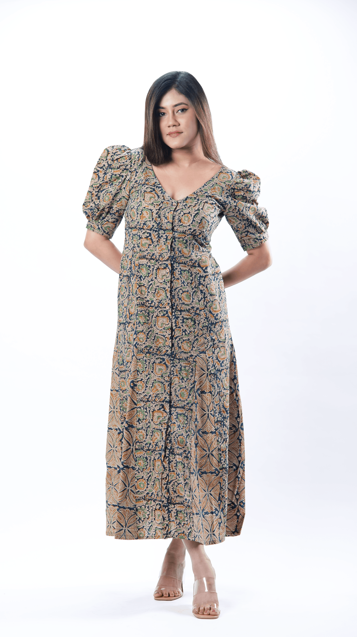 Introducing the elegant Vee Vista Dress in Ivory, with a sleek V-neck front and back, intricate hem paneling, and charming puff sleeves. This cotton dress for women blends sophistication with playful flair, ideal for any occasion. Explore our collection of printed dresses and calf-length options!