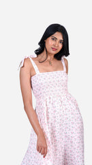 Step into style with Sevy's Pink Floral Midi Dress, featuring a stretchy, shirred bust and functional straps for easy, slip-on wear. Crafted from seersucker cotton, this knee-length dress combines floral elegance with practicality, including subtle side pockets. Ideal for everyday wear or casual outings, shop this floral print dress now at Sevy.in!