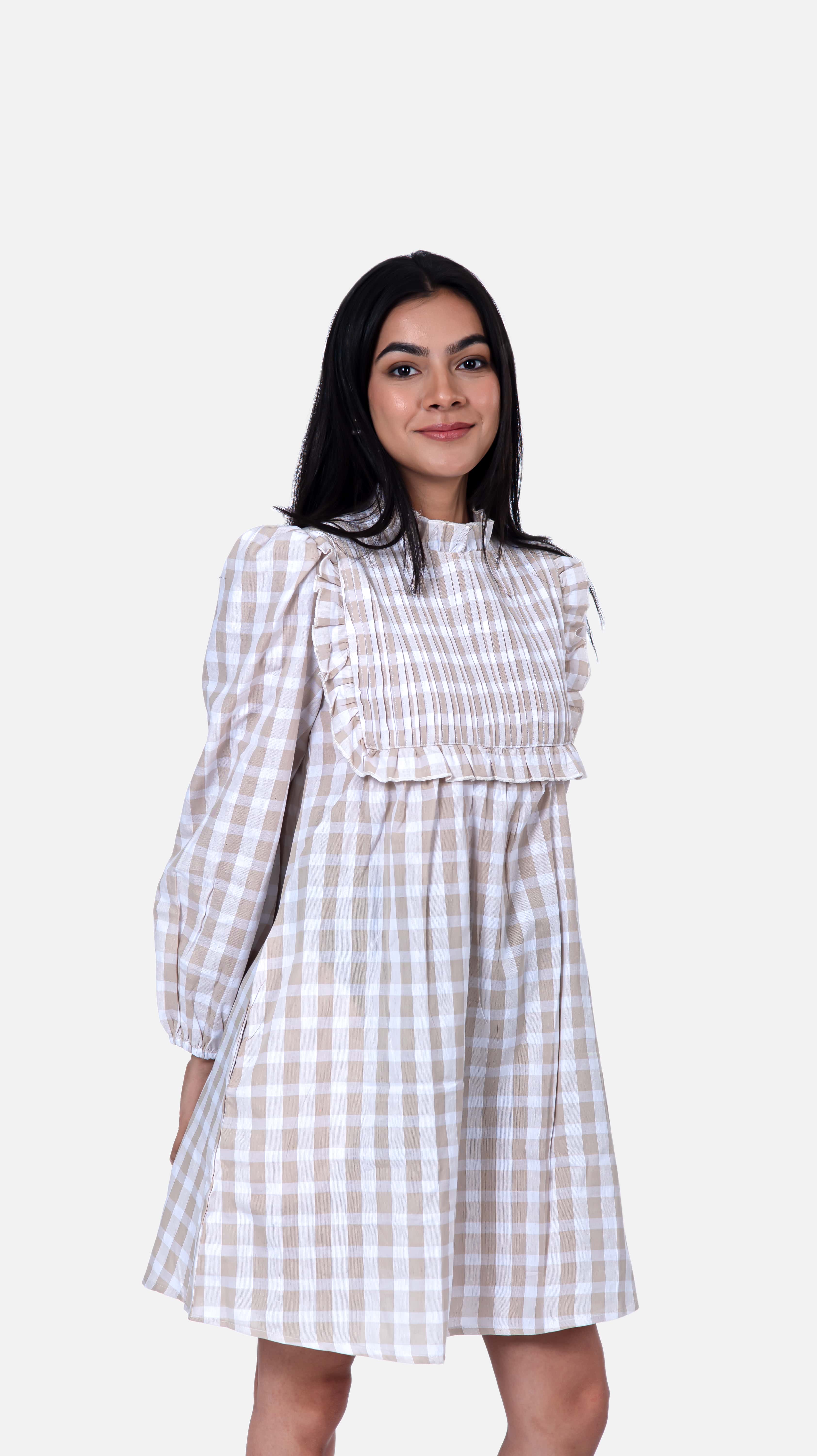 Discover sophistication with Sevy's beige pintucked mini dress in a stylish checkered pattern. Made from 100% cotton seersucker, it offers timeless elegance with its intricate detailing. Perfect for any occasion, from casual outings to formal events, this flared dress is a versatile addition to your collection. Explore our long dresses for women and beige dress options at Sevy.in