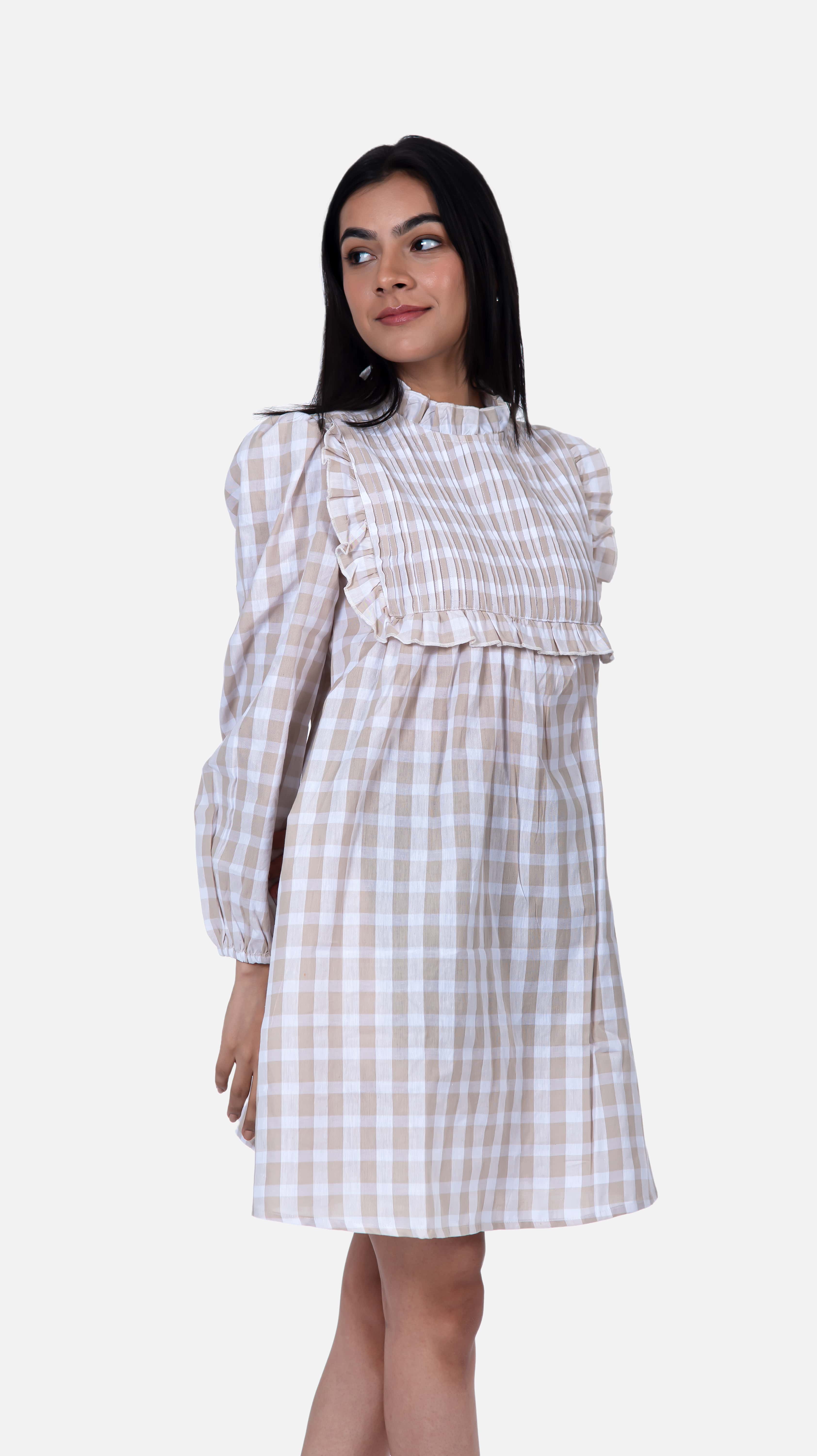 Make a statement with Sevy's mini checkered dress in beige, featuring elegant pintuck detailing. Crafted from 100% cotton seersucker, it offers both style and comfort. Ideal for women seeking a versatile wardrobe piece, suitable for casual days or dressed-up evenings. Shop now for mini dresses and short dresses for women at Sevy.in!