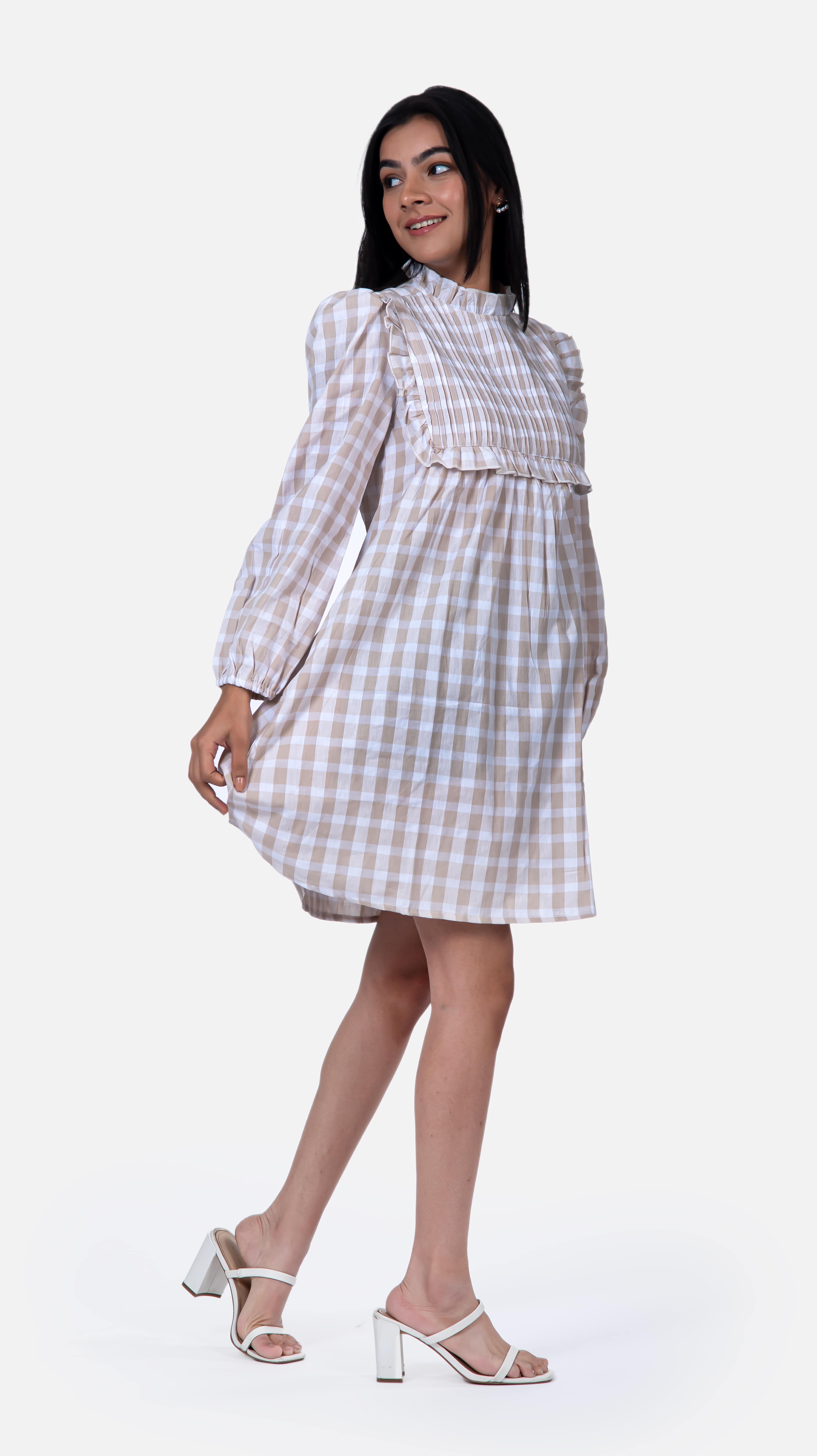 Step out in style with Sevy's elegant beige pintucked mini dress, crafted from 100% cotton seersucker. The intricate pintuck detailing adds a touch of sophistication to this versatile piece, perfect for both casual and formal occasions. Explore our range of check dresses and beige dresses for women at Sevy.in!