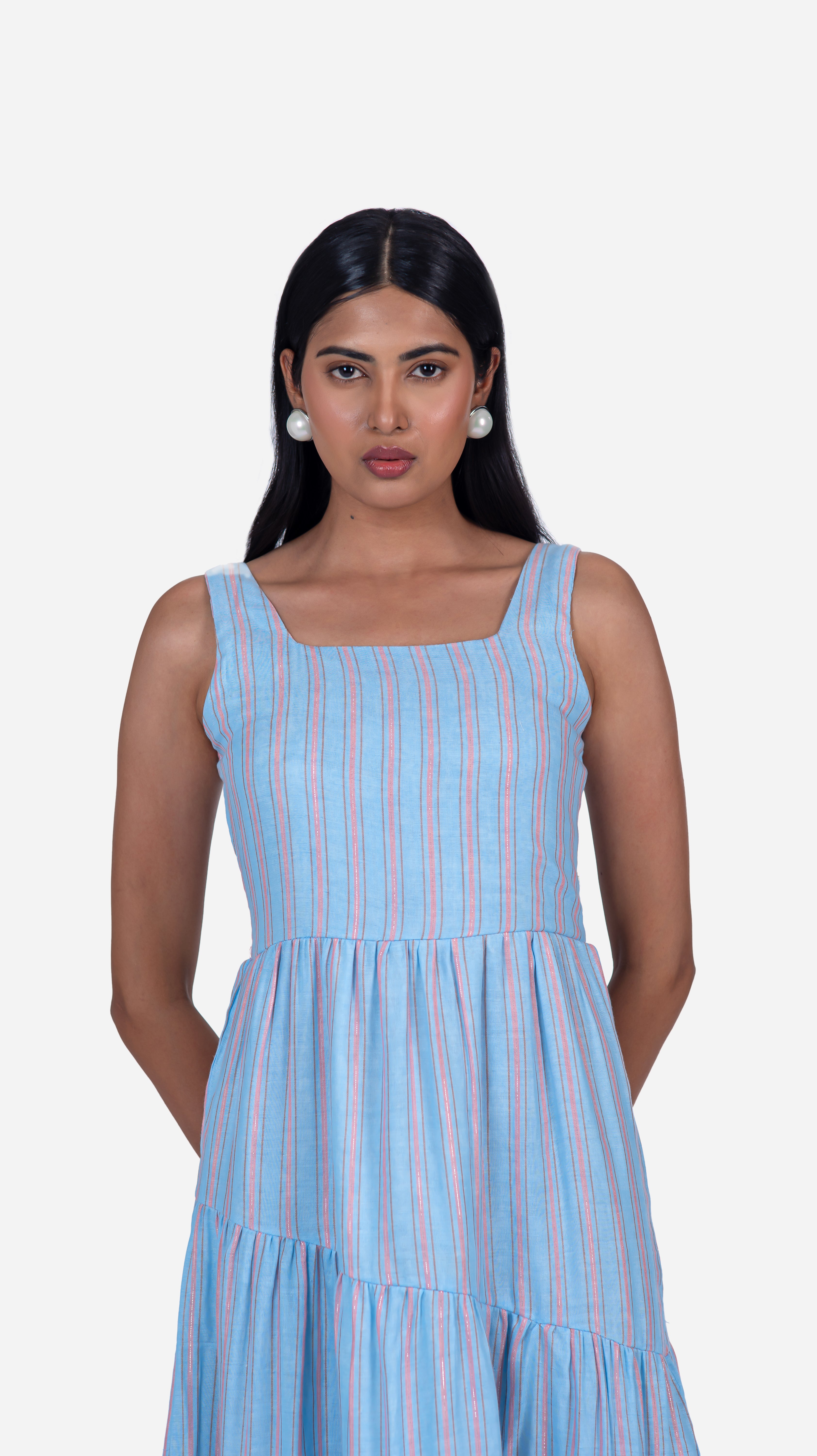 Elevate your wardrobe with Sevy's Ocean Blue Strips midi dress, designed with a sleeveless silhouette and crafted from 100% cotton. Featuring playful three layers of flares and a chic square-cut neckline, it's perfect for the modern woman. Shop now for knee-length dresses for women and printed dresses at Sevy.in!